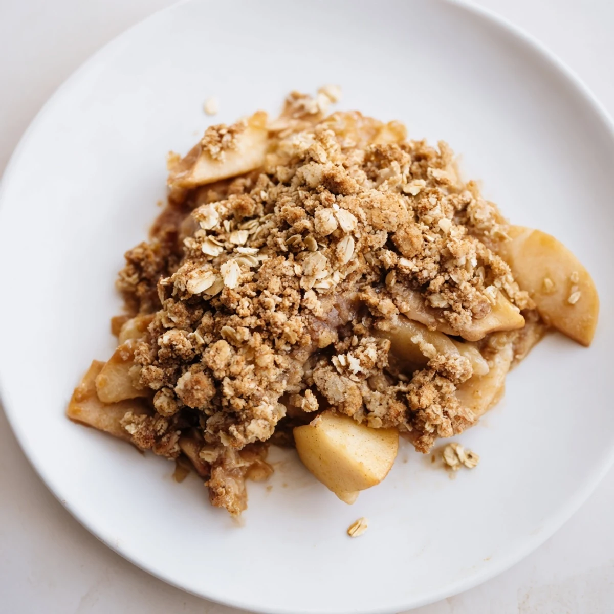 Homemade apple cinnamon crumble, a dessert with a sweet, baked aroma, perfect with ice cream.