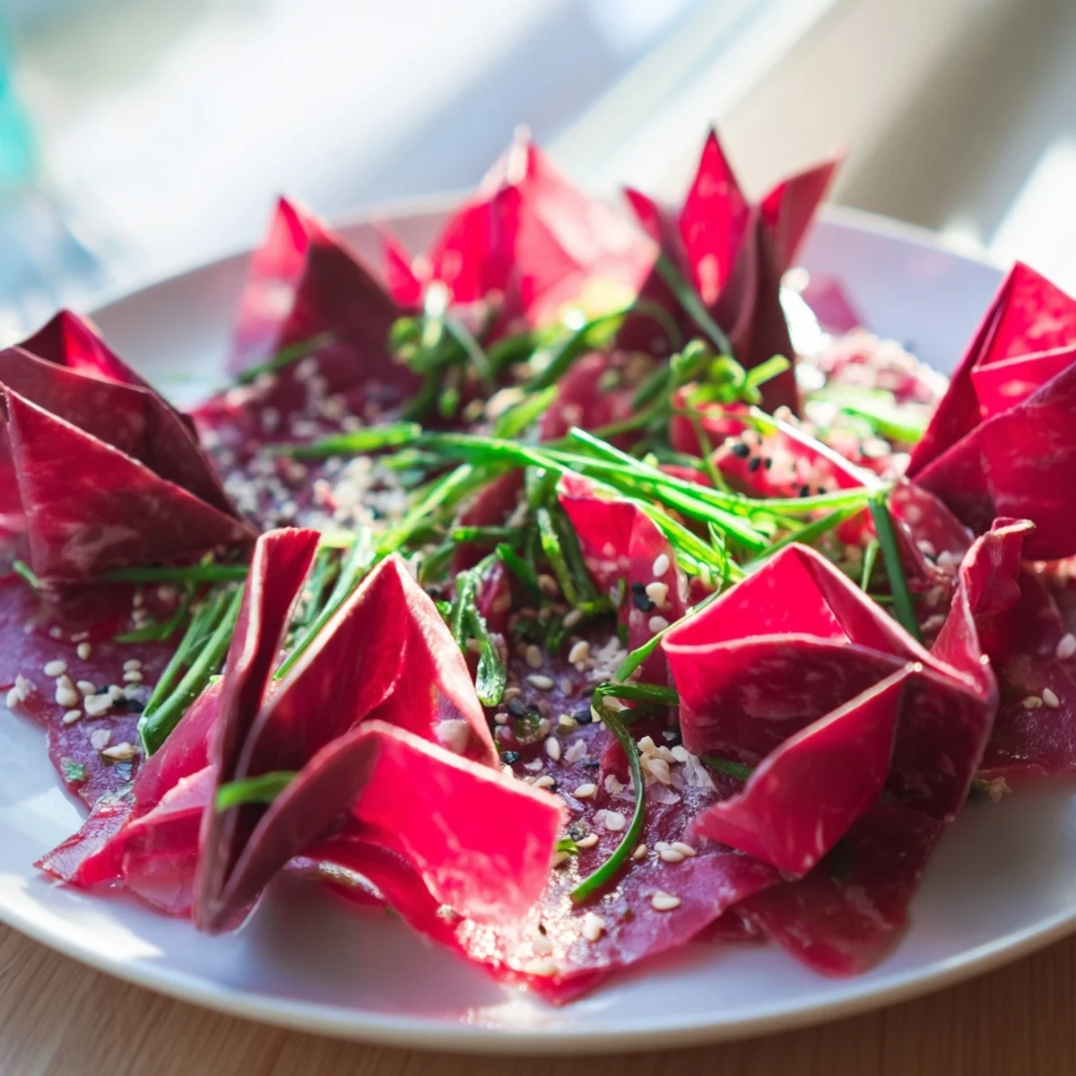 Showstopping plate of Origami Fold Beef Appetizer: intricately folded beef with Parmesan and chives, perfect starter.