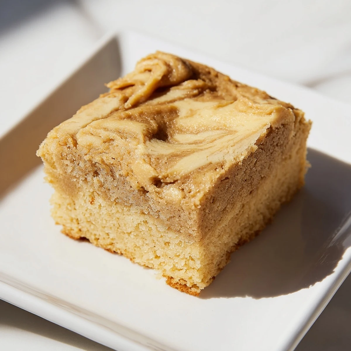 Warm Peanut Butter Mochi Cake, ready to serve, promises a delightful treat, blending Asian and American influences for you.