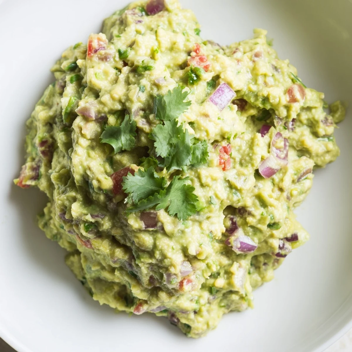 Creamy green edamame guacamole served with fresh tortilla chips, a flavorful Mexican appetizer.