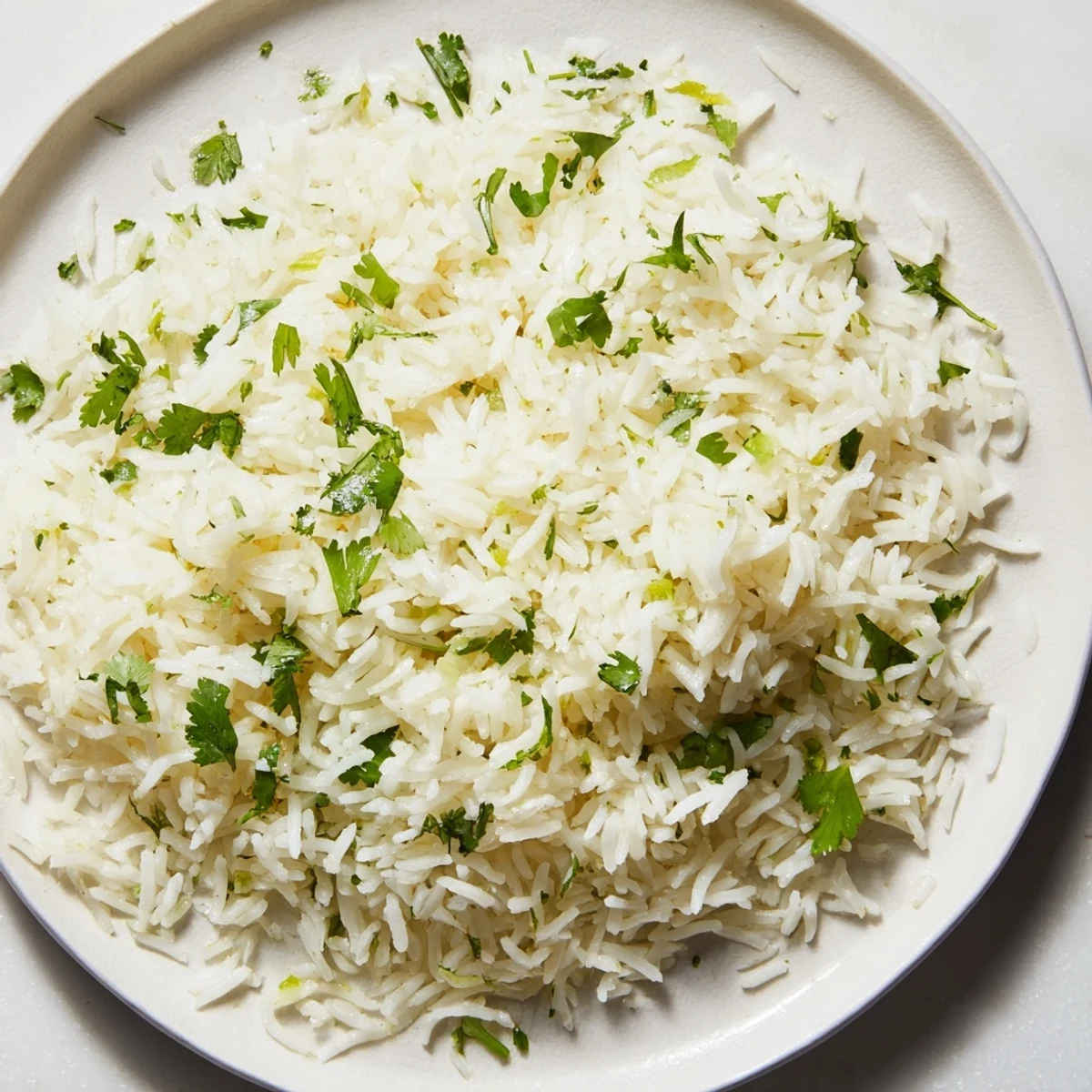Fluffy Cilantro Lime Rice, vibrant green flecks of cilantro; perfect side dish for tacos or chicken.