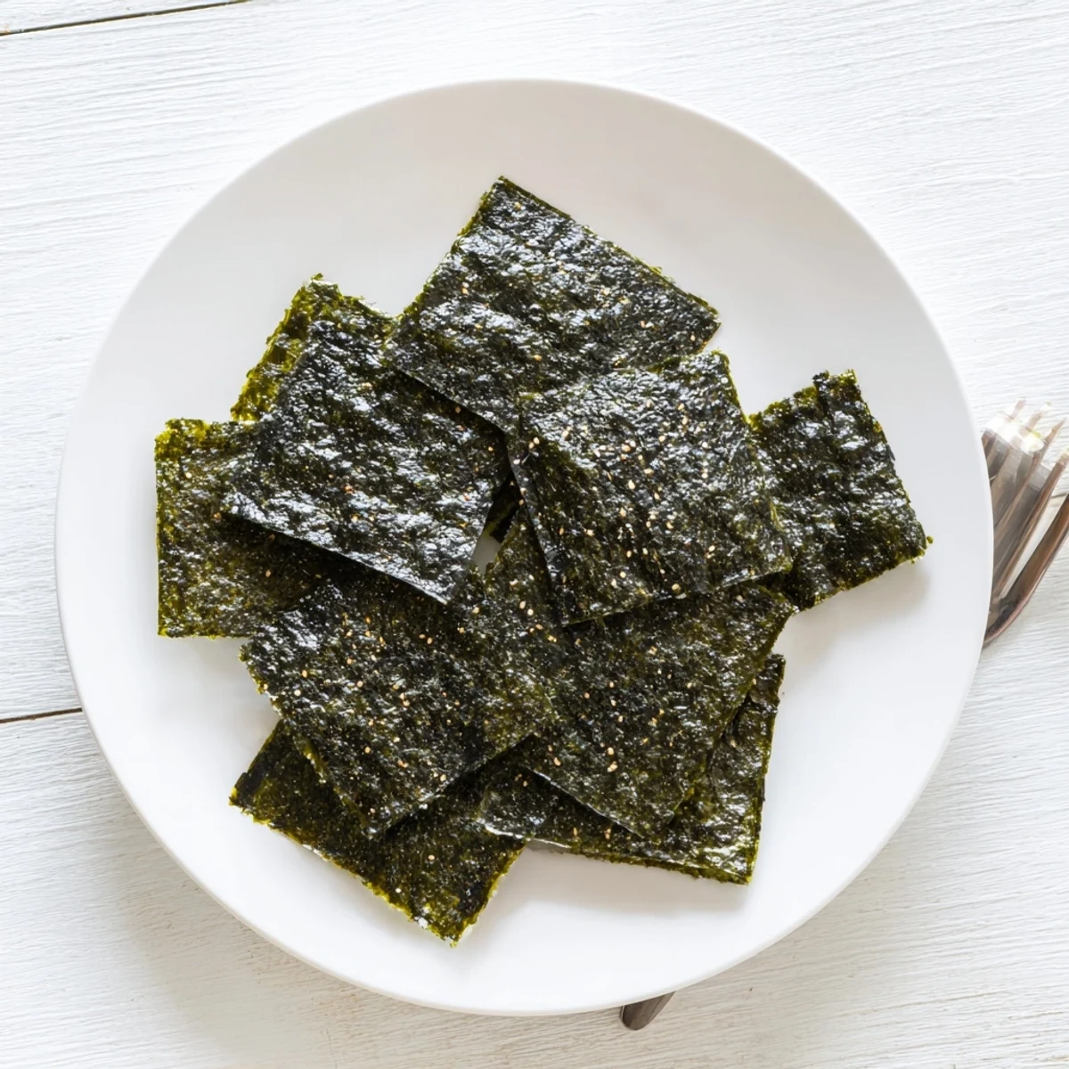 A close-up of crispy Roasted Seaweed Chips, showcasing their dark green color and crunchy, freshly roasted texture.