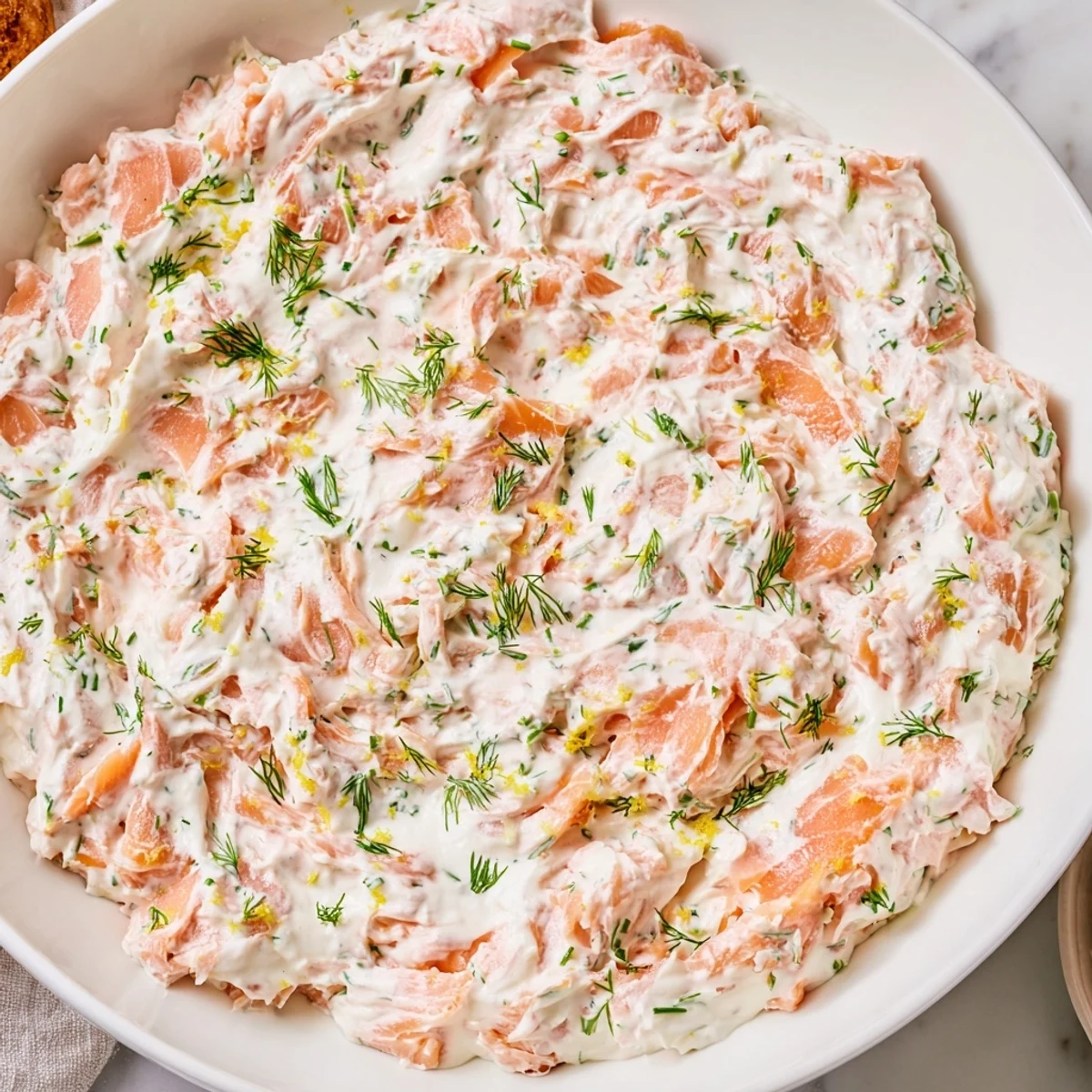 This elegant Smoked Salmon Dip features finely chopped salmon mixed into smooth cream cheese, perfect for entertaining on a wooden board.  