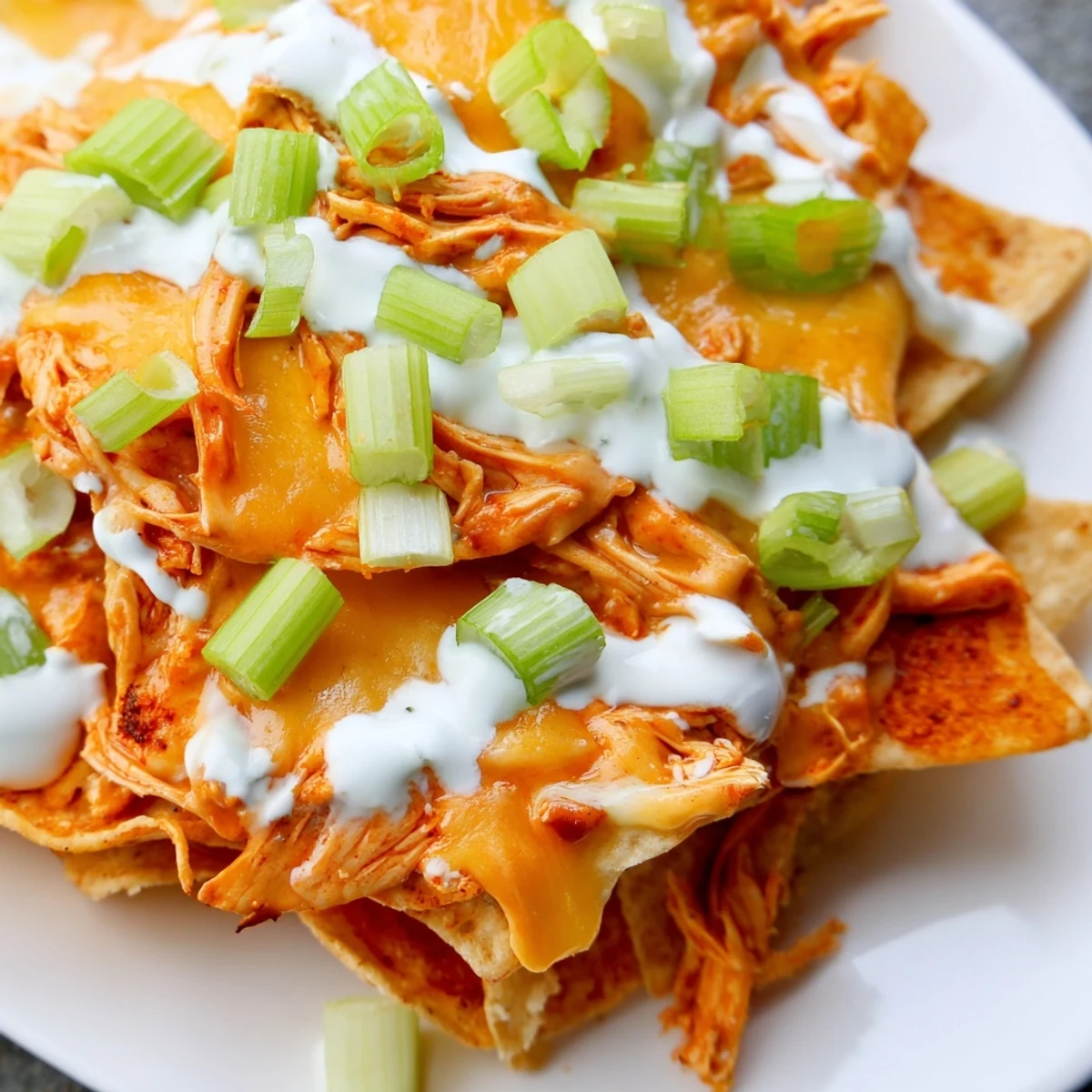 Sizzling Buffalo chicken nachos baked until golden, served with crisp veggies and creamy ranch drizzle.