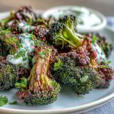 Golden crisp harissa broccoli on warm flatbreads served with lemon wedges.