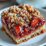 Deliciously sweet and tart strawberry rhubarb crumble bars, perfect for dessert.