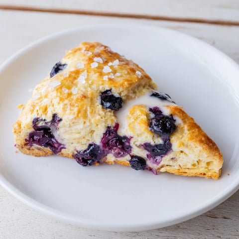 Golden-brown Rustic Birch-Warm Blueberry Scones, freshly baked and ready for a delicious breakfast.