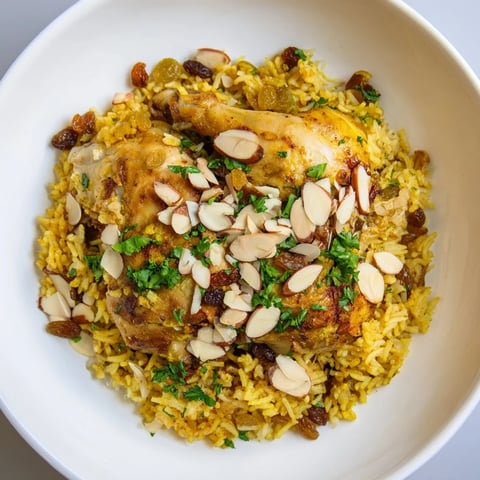 Golden saffron chicken and rice pilaf, a warm, inviting one-pot meal with savory, tender chicken.