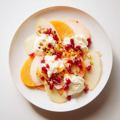 Persimmon and pear snowscape: A beautiful dessert with creamy mascarpone, fruit, and bright pomegranate seeds.