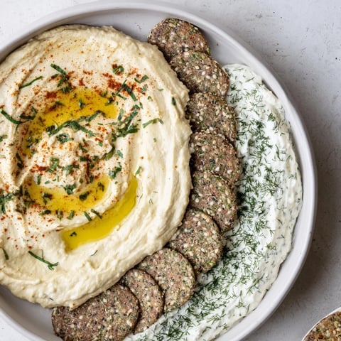 Two bowls of Easy Dips separated by crackers, perfect for scooping and sharing at a party.