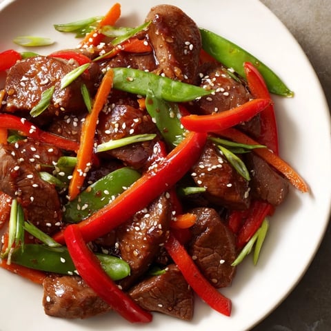 Sweet teriyaki pork stir-fry, a colorful dish with tender pork, in a sweet soy glaze, served over rice.