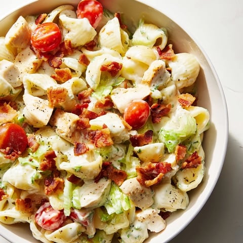 Creamy BLT Chicken Pasta Salad with grilled chicken, crispy bacon, ripe tomatoes, and crisp lettuce in a light mayo dressing.