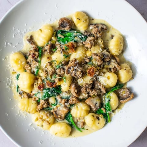Sizzling woodsy skillet sausage and mushroom gnocchi with browned sausage and tender gnocchi.