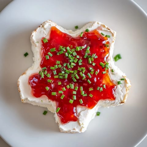 This Cream Cheese and Pepper Jelly Star Appetizer features a creamy, star-shaped display perfect for gatherings.