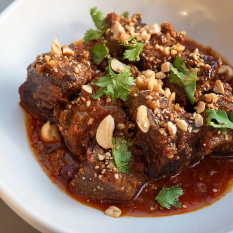 Close-up of a richly flavored Moroccan Lamb Tagine, showcasing the slow-cooked lamb.