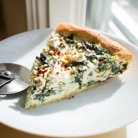 Freshly baked Spinach Ricotta Pizza slice with golden crust, creamy ricotta, sautéed spinach, and garlic butter.