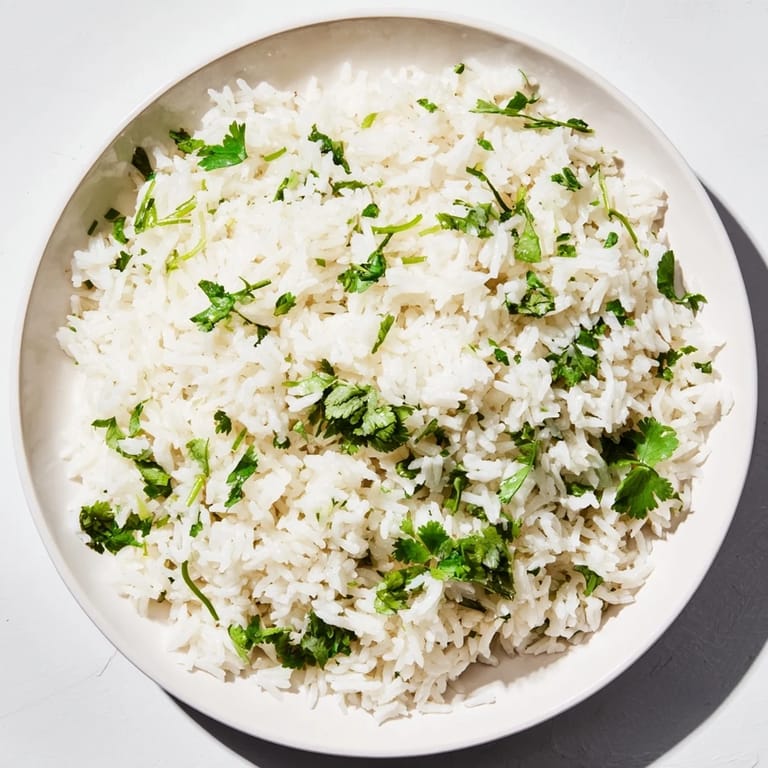 Bright, zesty Cilantro Lime Rice: Fluffy grains infused with lime and cilantro, ready to serve warm.