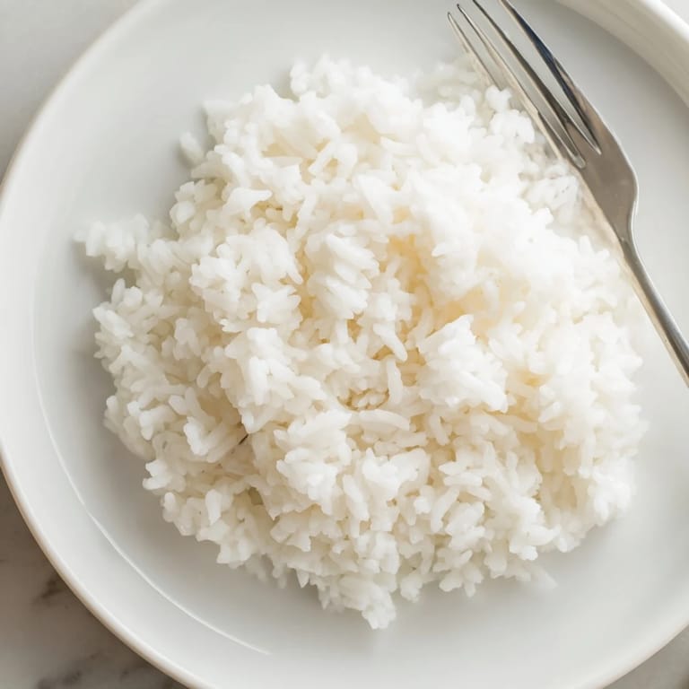 Steaming Coconut Jasmine Rice – a fragrant, simple side, perfect to complement any meal's flavors.